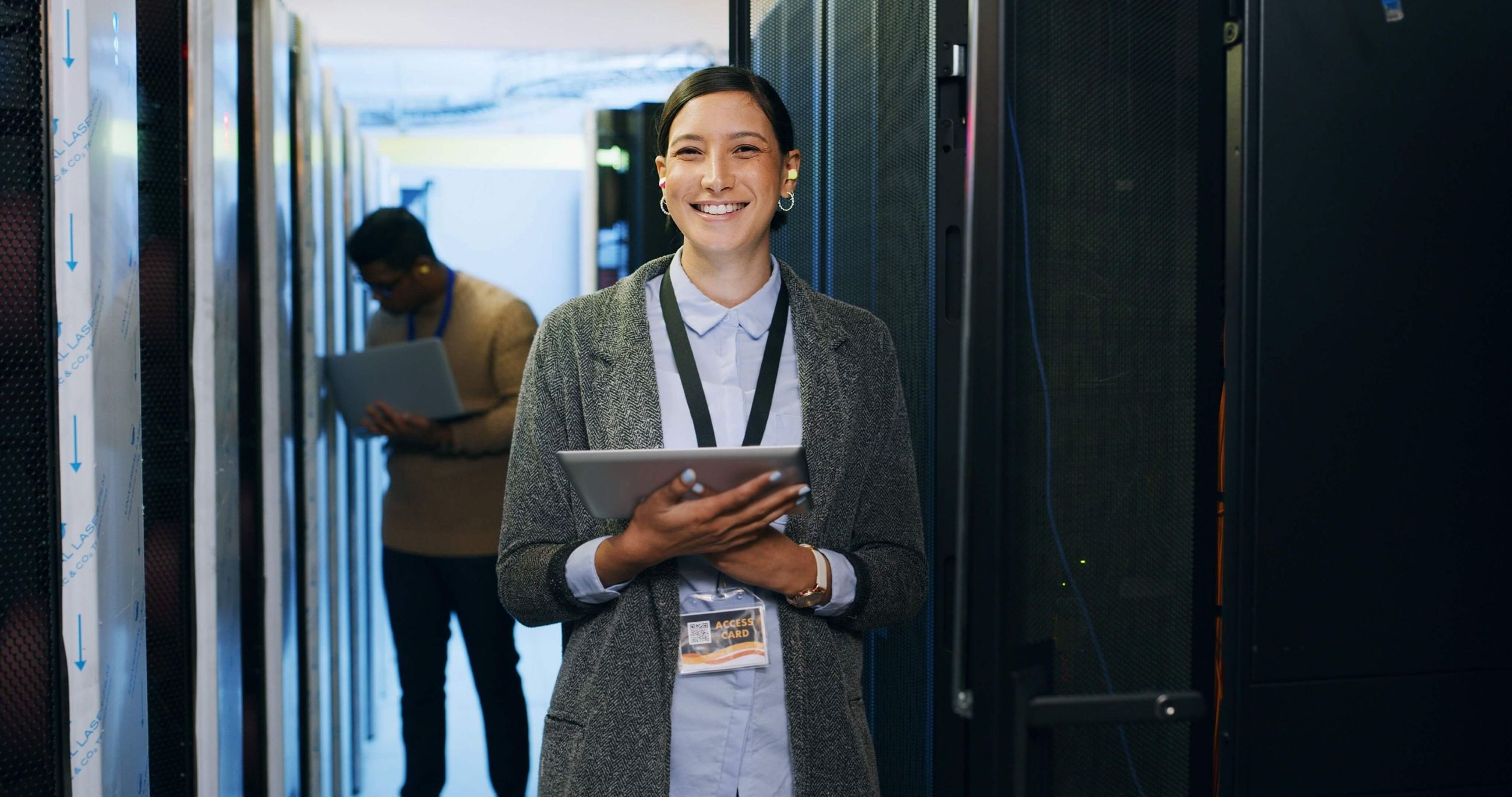 Professional in a data center with a tablet